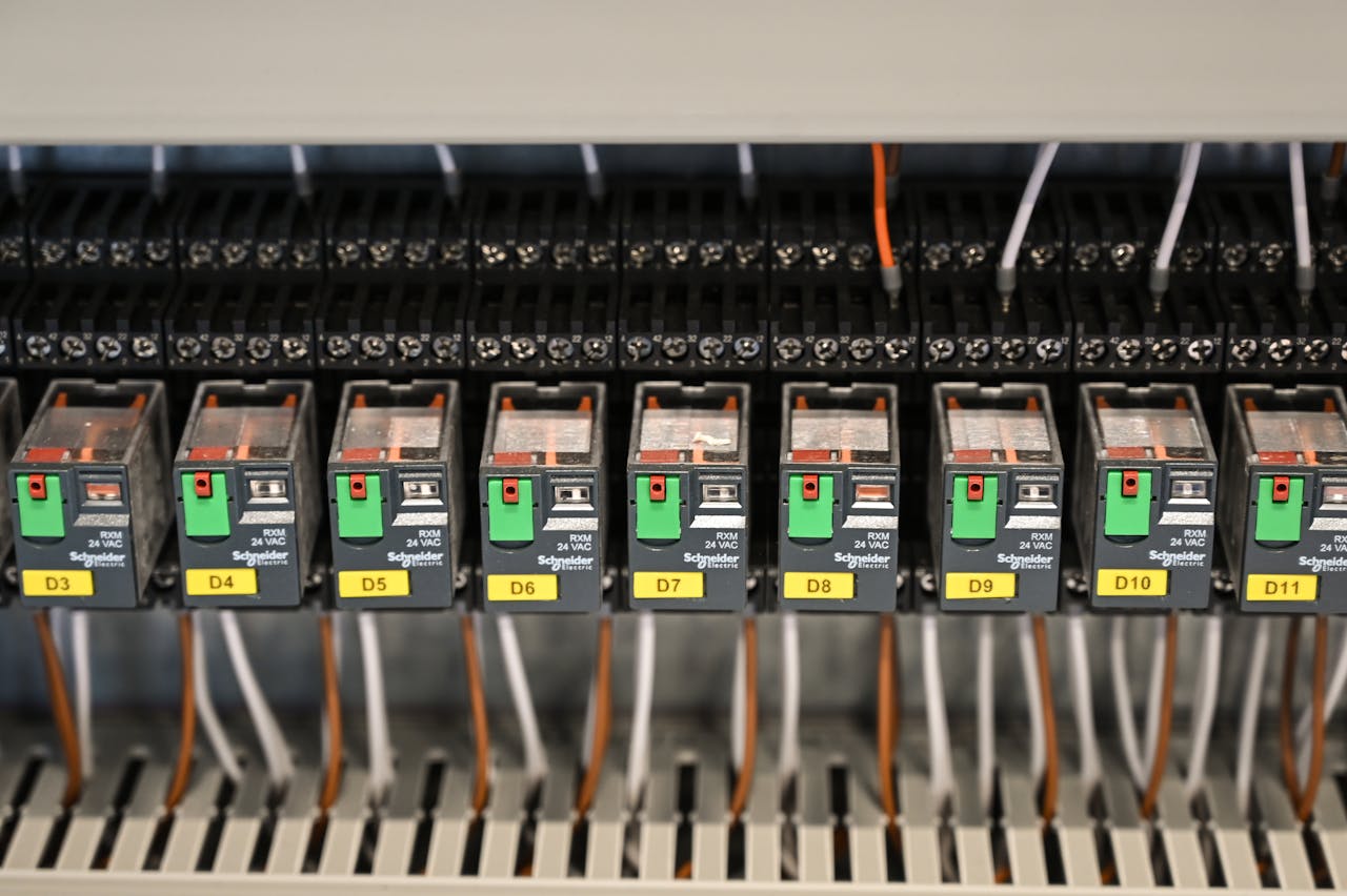 services-10 Close-up view of electrical relays in an industrial panel box showcasing circuit components.