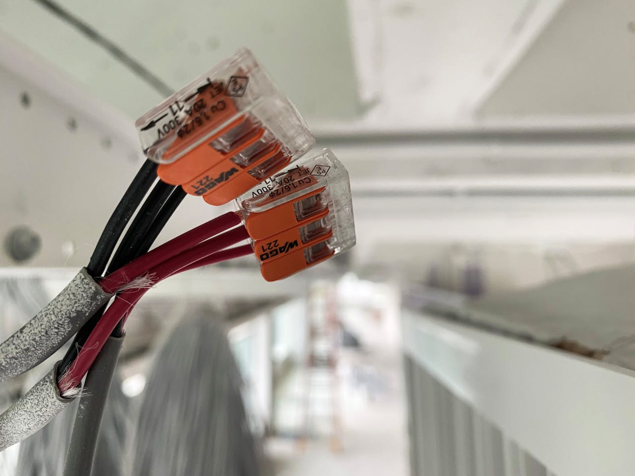 The Art of Drawing Readers In: Your attractive post title goes here Detailed view of splicing connectors and wires in an indoor setting, ideal for technology-related projects.
